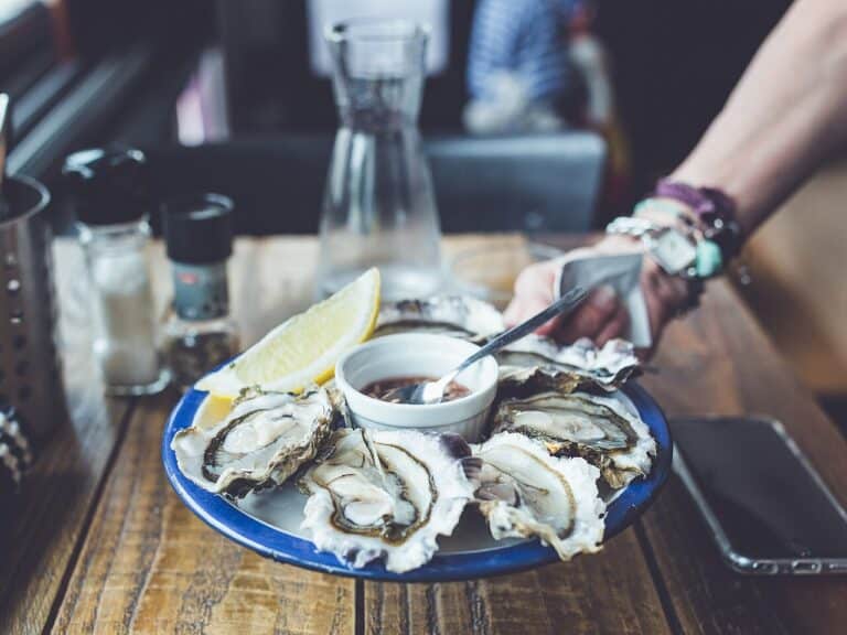 Fresh shucked oysters on a plate at a Ballard oyster bar