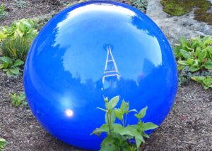 Vivid blue glass sphere reflecting the Space Needle at Chihuly Garden and Glass